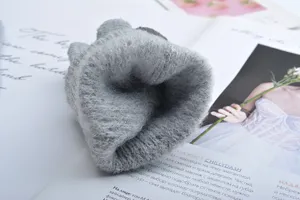 Detailed view of grey knitted fleece-lined winter warm gloves, soft touch and cozy texture.