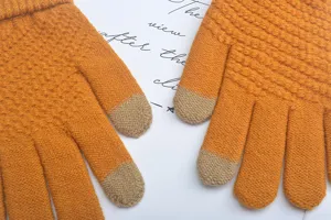 Detail view of yellow knit touch screen gloves, warm winter five-finger gloves close-up