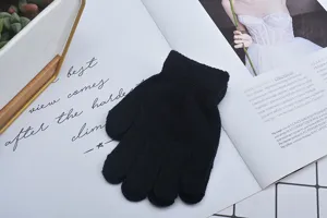Detailaufnahme schwarzer Strickhandschuhe mit weicher warmer Fünf-Finger-Textur für Kinder.