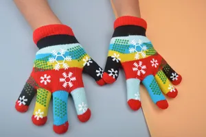 Detailed shot of kids colorful knitted gloves, snowflake pattern, warm winter five finger design.