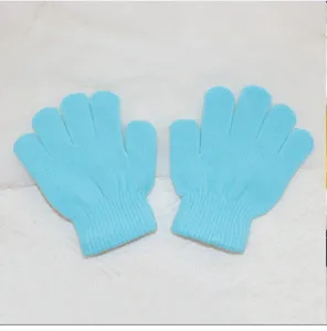 Detailed close-up view of light blue children knitted gloves, showing fine texture and soft fabric.