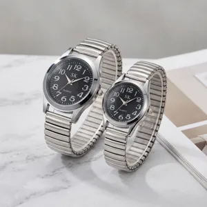 Silver stainless steel quartz watch pair with black dial, large numbers and expansion band.