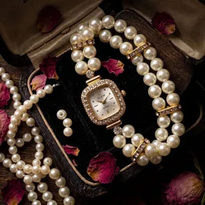 Elegant double-row pearl rhinestone quartz watch with square dial and elastic bracelet band.