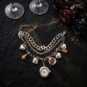 Elegant multi-layer charm bracelet watch with heart pendants and quartz dial for women.