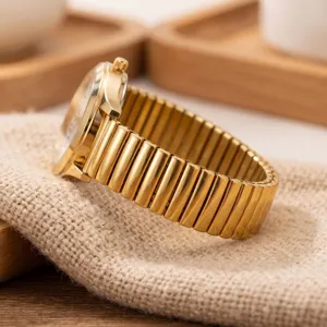 Gold quartz watch for elderly with elastic expanding metal strap. Clear analog dial design.