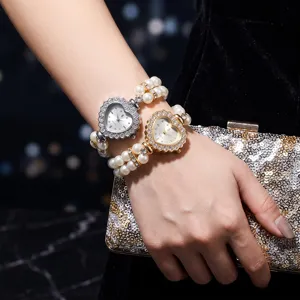 Heart-shaped rhinestone quartz watch with double-row pearl elastic bracelet detail view.