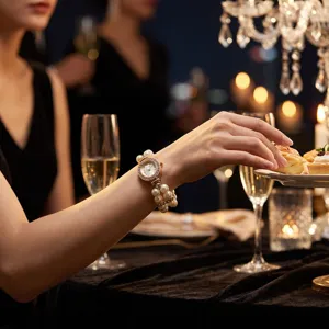 Elegant double-row pearl elastic quartz watch with rhinestone floral dial for women.