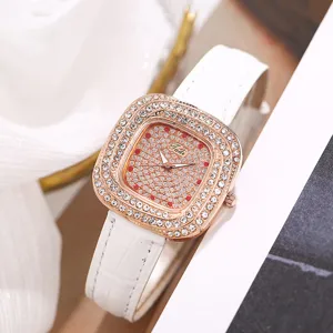 Close-up detail of square diamond women quartz watch with white leather strap and dial