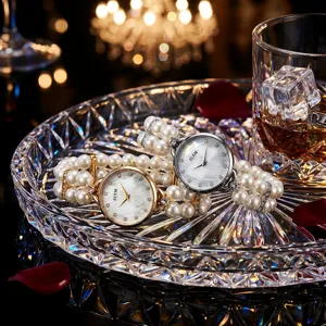 Pearl quartz watch detail showing double-row elastic bracelet design with rhinestone dial accents.