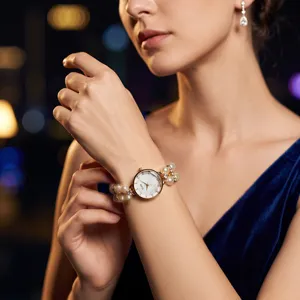 Women's elegant quartz watch with double row faux pearl stretch bracelet and rhinestone crystal details.