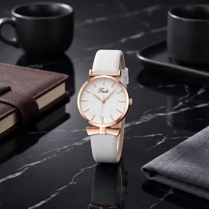Detailed shot of women quartz watch with white faux leather strap and rose gold case.