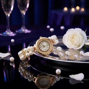 Stunning detail view of a pearl stretch bracelet watch with crystal bezel on a silver tray.
