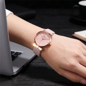 Close-up detail of women quartz watch with pink leather strap bow and leaf embossed dial.