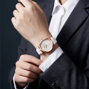 Elegant women's quartz watch with rose gold case, white leather strap and leaf embossed dial.