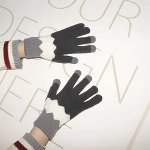 Close-up detail of winter warm knitted touch screen gloves with color block design.