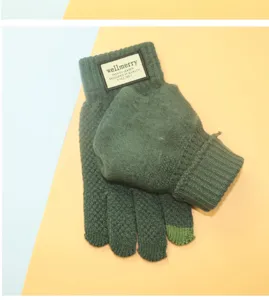 Detailed view of green winter touch screen knit gloves with plush lining and cuff label.