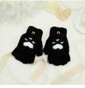 Close-up detail view of black fluffy cat paw half-finger flip gloves, cozy winter warm accessory.