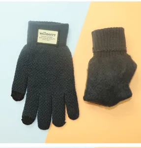 Close-up of thick fleece lined touchscreen knit gloves in dark gray with brand patch detail.