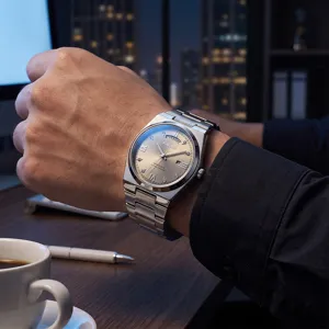 Men's quartz watch with stainless steel integrated bracelet, champagne dial, and daydate ready.