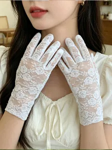 Detailed close-up of elegant white lace gloves featuring delicate floral embroidery for summer.
