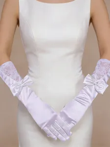 Elegant long white bridal satin gloves featuring delicate lace panels and charming bow accents.