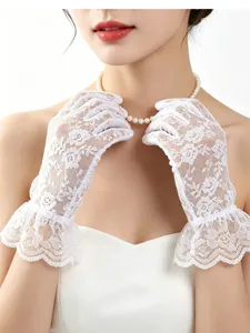 Close-up of white lace gloves featuring delicate floral embroidery and elegant ruffled cuffs.
