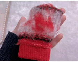 Plush knit glove detail, soft red and white fuzzy texture closeup, cozy winter accessory.
