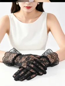Close-up detail view of elegant black lace floral summer UV protection gloves worn by model.