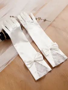 Elegant white satin opera gloves featuring delicate lace panels and a cute bow detail for bridal wear.