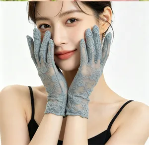 Detailed view of elegant grey lace sun protection gloves, perfect for summer tea parties or bridal wear.