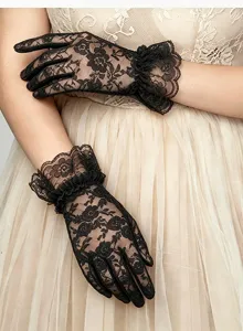 Detail view of elegant black lace gloves featuring floral patterns and ruffled wrist cuffs.