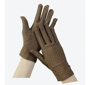 Detailed view of brown polka dot stretch women gloves, soft fabric and classic pattern detail.
