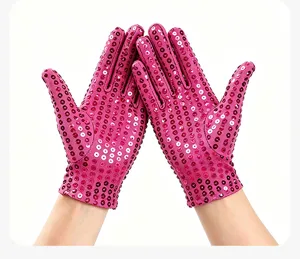 Close-up detail of vibrant pink sequin dance gloves designed for stage performance.