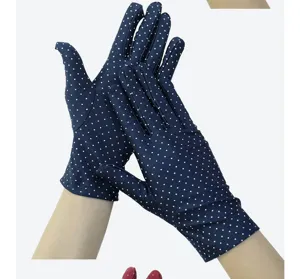 Detail view of women's dotted sun protection gloves, highlighting stretch fabric.