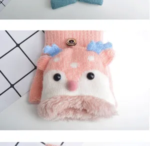 Cute deer design kids winter gloves detail, warm knitted half finger flip top fleece lined close up.