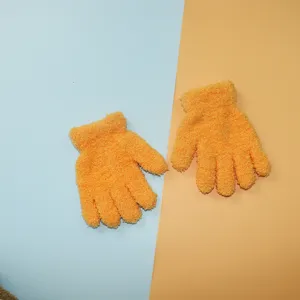 Close-up shot of soft orange fuzzy winter gloves, perfect for kids' outdoor wear and daily warmth.
