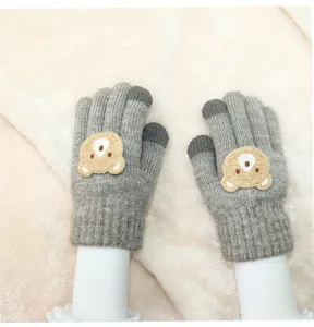 Close-up of children's grey knitted gloves featuring cute bear applique and touch screen fingertips detail.