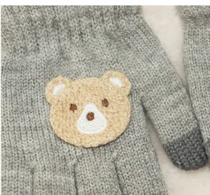 Close-up detail of kids winter warm knit gloves featuring cute bear embroidery design.