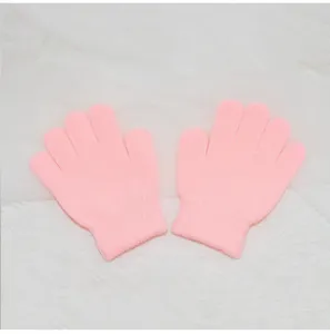 Detail view of cute pink knitted five-finger gloves for kids, showing soft fabric and fine texture.