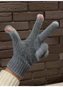 Close-up detail of grey winter warm knitted touchscreen gloves with exposed fingers.