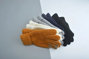 Knitted touchscreen gloves detail shot, warm winter five-finger gloves in various colors.