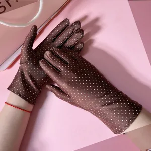 Close-up detail of brown ice silk sun protection gloves with white polka dots for women.