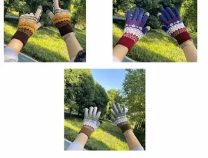 Detailed view of colorful knitted touch screen gloves outdoors, showcasing warm geometric patterns.