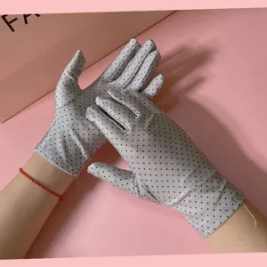 Detailed view of women summer thin sun protection ice silk polka dot gloves for driving.
