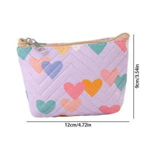Detailed view of the cute purple leather coin purse with colorful hearts and zipper closure.