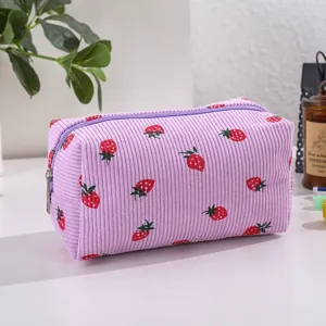 Purple corduroy strawberry print makeup bag detail view, cute cosmetic pouch zipper close.
