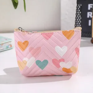 Cute pink leather coin purse detail featuring colorful heart quilted patterns and zipper closure.