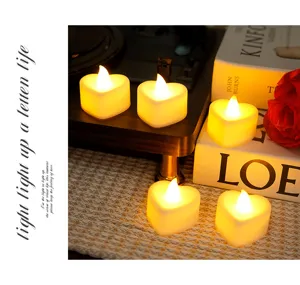 Heart LED candle light detail showing warm glow and romantic atmosphere setup on table.