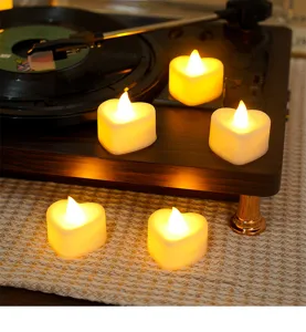 Heart-shaped LED electronic candles in a warm ambient scene, perfect for romantic desktop decor details.