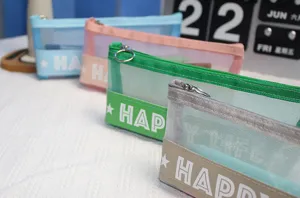 Close-up detail of colorful mesh pencil case with transparent design and zipper closure.